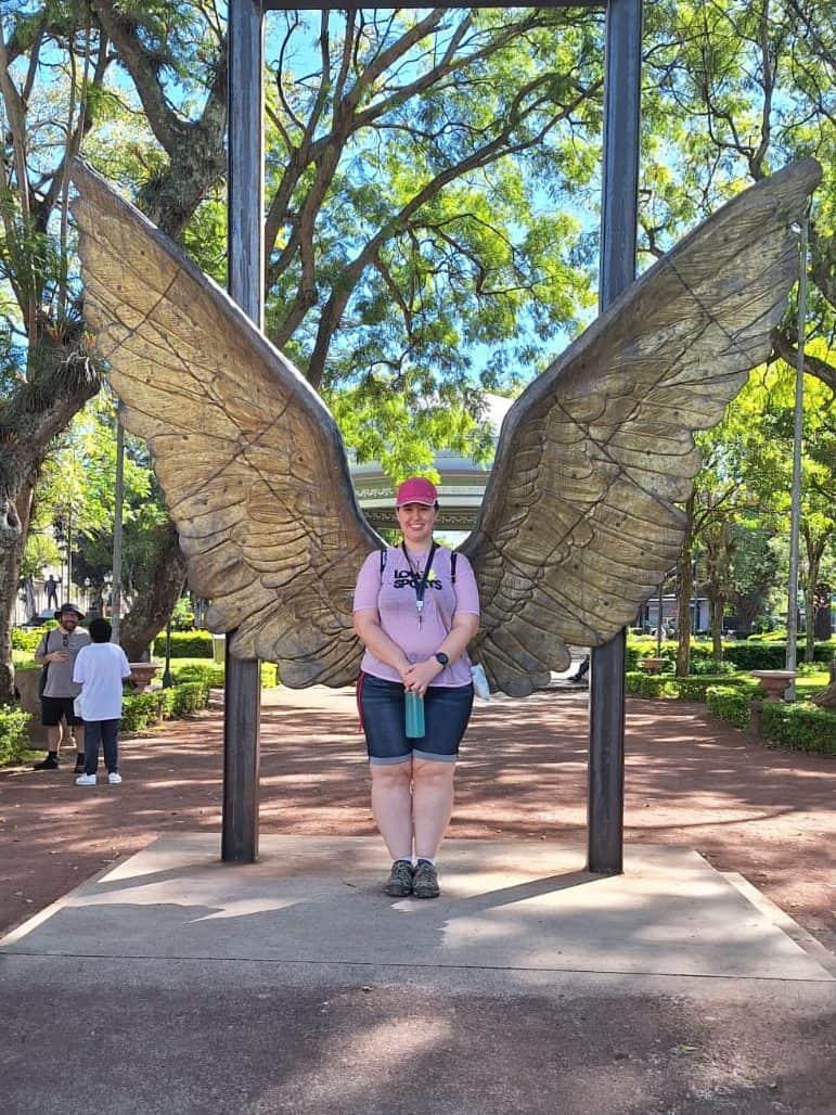 Amanda Jakle in front of angel wings in San Jose Costa Rica